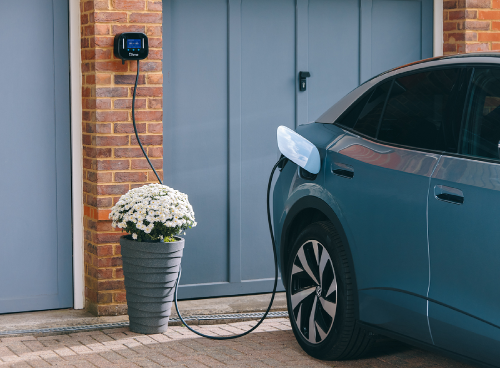 Ohme Home Pro EV charger with 8-metre cable charging a blue Volkswagen ID.3 on a residential driveway